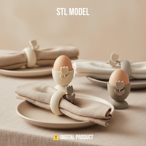 May include: A table setting with beige plates, napkins, and egg cups. The napkins are held by tulip-shaped napkin rings. Two eggs sit in tulip-shaped egg cups. The text "STL MODEL" and "DIGITAL PRODUCT" are visible.