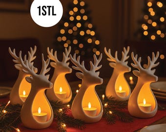 May include: Six white ceramic reindeer candle holders with lit tea lights inside, arranged on a red tablecloth. The reindeer have detailed antlers and a cutout for the candle. The background includes a Christmas tree with lights and the text "1STL".