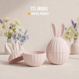 Może przedstawiać: Jasnoróżowy pojemnik w kształcie królika z pokrywką i oddzielną miską. Pojemnik ma żebrowaną fakturę i uszy królika na górze. Widoczny jest tekst "STL MODEL DIGITAL PRODUCT".