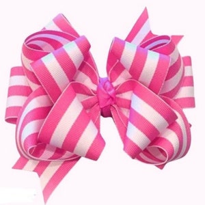 May include: A pink and white striped hair bow with a large, double loop design.