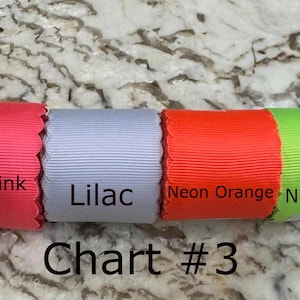 May include: Four rolls of scalloped edge ribbon arranged horizontally, labeled Neon Pink, Lilac, Neon Orange, and Neon Lime. The text Chart #3 is printed below the ribbons, which feature a ribbed texture and vibrant solid colors.