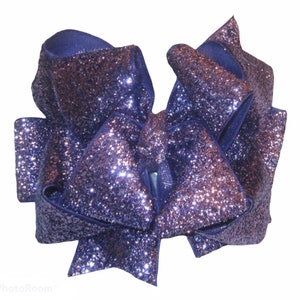 May include: A large purple glitter hair bow with a satin backing.