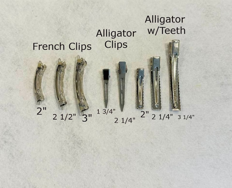 May include: A set of hair clips in various sizes, including French clips and alligator clips with teeth. The clips are arranged in order of size, with the smallest clip measuring 1 3/4 inches and the largest measuring 3 1/4 inches.