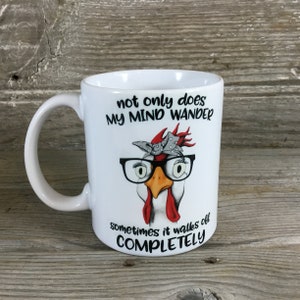 May include: White ceramic mug with a black and white illustration of a chicken wearing glasses and a red bandana. The text on the mug reads "not only does my mind wander sometimes it walks off COMPLETELY".