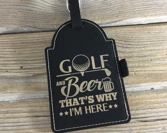 May include: Black leather golf and beer bag tag with gold lettering that reads "Golf and Beer That's Why I'm Here".