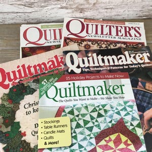 May include: A collection of quilting magazines with titles like "Quilter's Newsletter Magazine" and "Quiltmaker." The magazines feature colorful quilt patterns and projects, with text including "Tips, Techniques & Patterns" and "Holiday Projects."