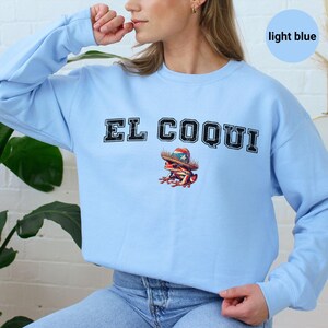Light blue El Coqui sweatshirt, vintage style graphic design, Puerto Rican heritage clothing, casual and comfy attire