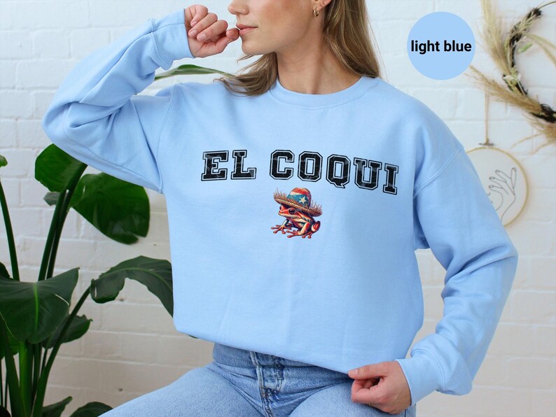 Light blue El Coqui sweatshirt, vintage style graphic design, Puerto Rican heritage clothing, casual and comfy attire