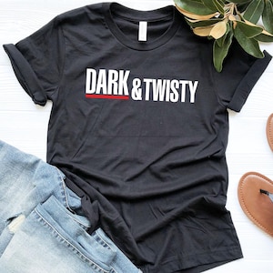 May include: Black t-shirt with white text that reads "DARK & TWISTY" with a red line under the text.