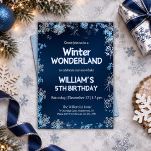 May include: A rectangular invitation card with a dark blue background and a border of silver and light blue snowflakes. The text reads: Come join us in a Winter WONDERLAND to celebrate our snowflake WILLIAM'S 5TH BIRTHDAY Saturday | December 12 | 1-3 pm The William's Home 76 Oakridge Lane, Maplewood, NJ Please RSVP to Olivia at 123-456-7890.