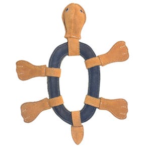 May include: A tan and navy blue dog toy shaped like a turtle. The toy has a navy blue oval body with tan appendages, including a head, four flippers, and a tail. The flippers are attached to the body with tan straps.