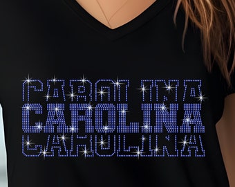 May include: Black v-neck t-shirt with a blue rhinestone design that reads "FIGHT FOR CAROLINA".