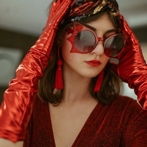 Shimmering, metallic crimson red caftan dress featuring v-neck at front and back.