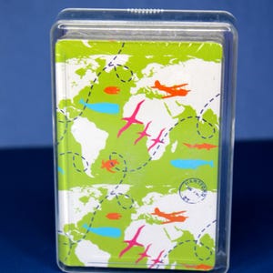 May include: A deck of playing cards in a clear plastic case. The card design features a green world map with orange airplanes, pink birds, and blue fish. The words "HARTFORD" and "CT" are visible.