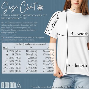 May include: White unisex t-shirt with a size chart. The chart provides measurements in inches and centimeters for length, width, and sleeve length. Sizes range from S to 4XL. The text reads "RELAXED 'BAGGY' FIT."