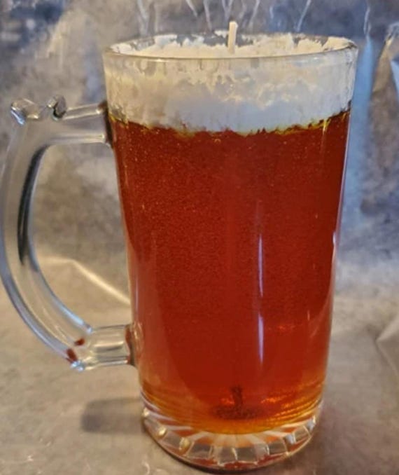 A candle poured inside a real glass beer mug that looks exactly like a full pint — the trompe-l'oeil joke lands every single time.
