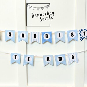 May include: A blue and white banner with the words "JESUS CHRIST IS THE ANSWER" in black letters.
