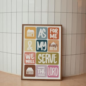 May include: A colorful framed print with the text "As for me & my house we will serve the Lord" in a stylized font. The print features a house icon in each of the nine squares.
