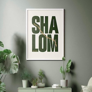 May include: A framed wall art print featuring the word SHALOM in large, dark green capital letters on a cream background. Overlaid in gold script is the text Peace I leave with you; my peace I give to you. John 14:27 is printed below.