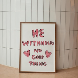 May include: A framed print with the text "HE WITHHOLDS NO GOOD THING" in pink lettering. Two pink hearts are on either side of the word "GOOD".