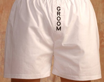 May include: White cotton boxer shorts with the word "GROOM" printed vertically down the front.
