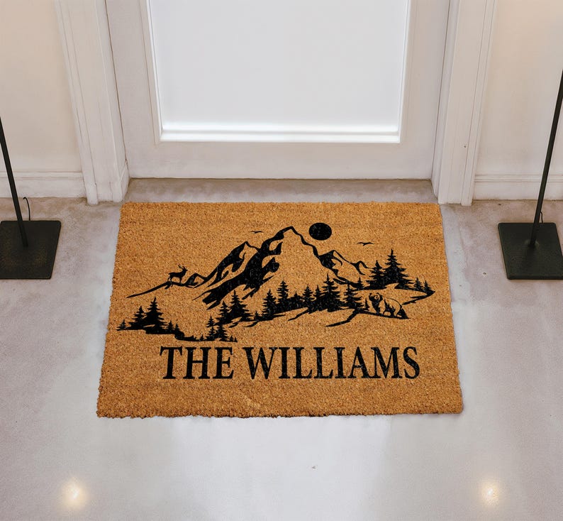 A door mat with a mountain landscape and the text "THE WILLIAMS" printed on it.