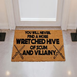 A door mat with a humorous message that reads "You will never find a more Wretched hive of Scum and villainy".