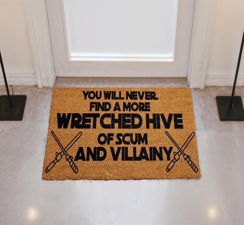 A door mat with a humorous message that reads "You will never find a more Wretched hive of Scum and villainy".