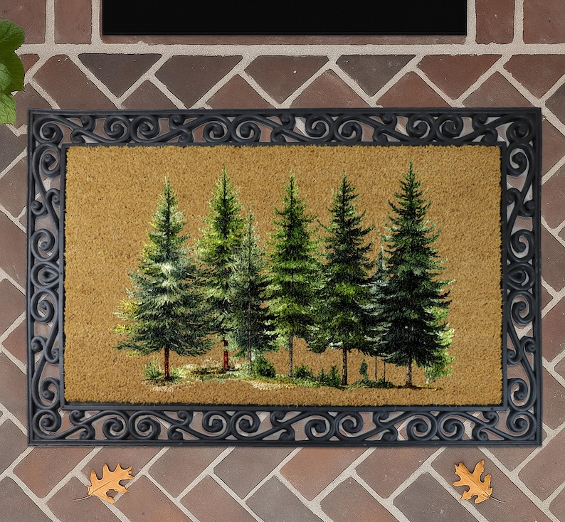 a decorative mat with a painting of a group of pine trees on it, placed on a brick wall.