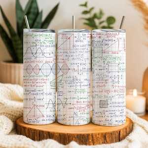 May include: Three stainless steel tumblers with lids and straws, each covered in a white grid pattern filled with mathematical equations, formulas, and diagrams. The tumblers are displayed on a wooden surface.