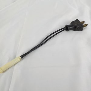 May include: A black electrical plug with two black wires connected to a cream-colored component. The plug has two prongs and is designed for electrical use. The item is set against a white background.