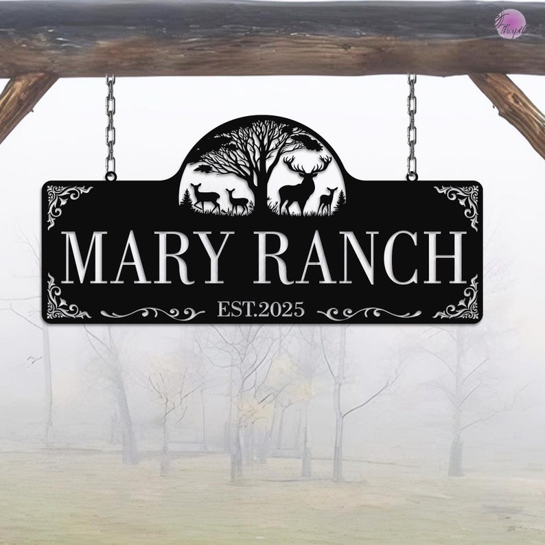 May include: Black metal sign with the words "MARY RANCH" in white, with a decorative tree and deer silhouette. The sign is suspended by chains and includes the text "EST.2025".