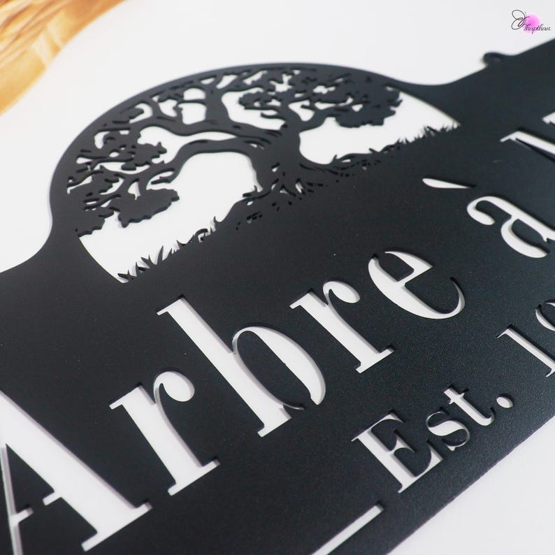 May include: Black metal sign with a cut-out tree design. The sign features the word "Arbre" and "Est. 19". The tree silhouette is detailed, and the sign is mounted on a white background.