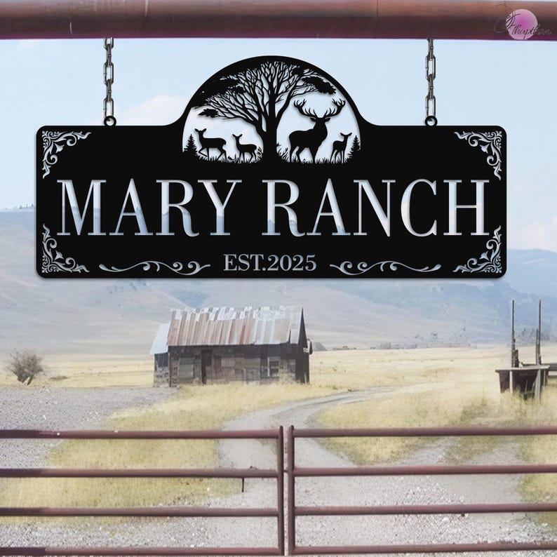 May include: Black metal sign with the text "MARY RANCH" and "EST.2025". The sign features a tree and deer silhouette design. The sign is hanging from chains.