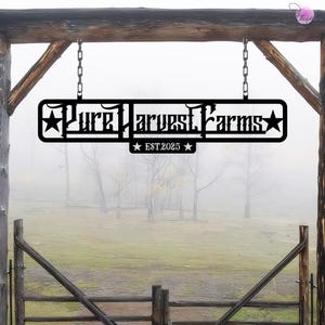 May include: Black metal sign with the text "Pure Harvest Farms" and "EST. 2025" hanging from a wooden structure. The sign is in front of a foggy field.