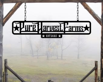 May include: Black metal sign with the text "Pure Harvest Farms" and "EST. 2025" hanging from a wooden structure. The sign is in front of a foggy field.