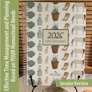 May include: A spiral-bound 2026 Homestead Planner with a patterned cover featuring illustrations of farm animals and objects. The planner includes the text "Effective Time Management and Planning Based on YOUR Homestead Needs."