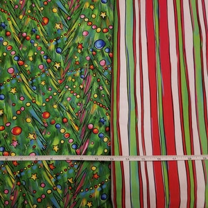 May include: Two fabric swatches, one with a green background and a pattern of stylized Christmas trees with colorful ornaments and stars, and the other with a white background and red and green stripes.