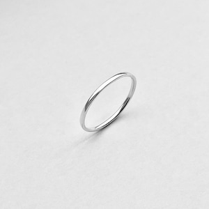 May include: A simple silver band ring. The ring is thin and delicate, with a smooth, polished finish.