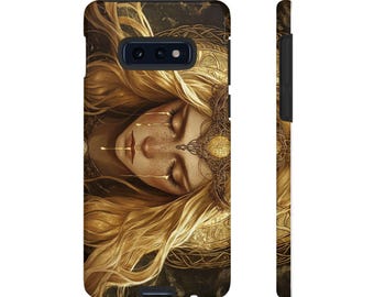 May include: A phone case with a golden design featuring a woman with long blonde hair and a crown. The woman's eyes are closed and she appears to be crying golden tears.