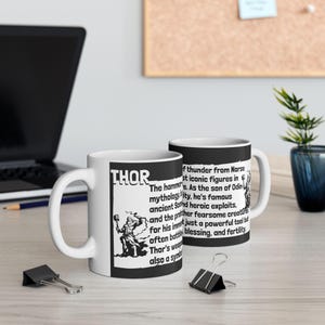 May include: White ceramic mug with a black background and white text that reads "THOR". The text describes Thor as the god of thunder from Norse mythology and the son of Odin. The mug features a black and white illustration of Thor holding a hammer.