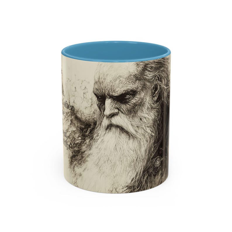 May include: A ceramic mug featuring a detailed black and white illustration of an elderly man with a long white beard and a blue interior. The mug has text on the side and is a unique gift idea.