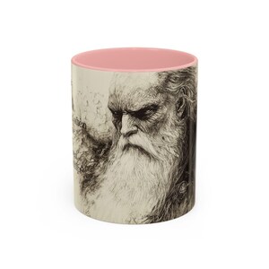 May include: A ceramic mug featuring a pink interior and a detailed black and white illustration of an elderly man with a long white beard. The mug has text on the side and is a unique gift idea.