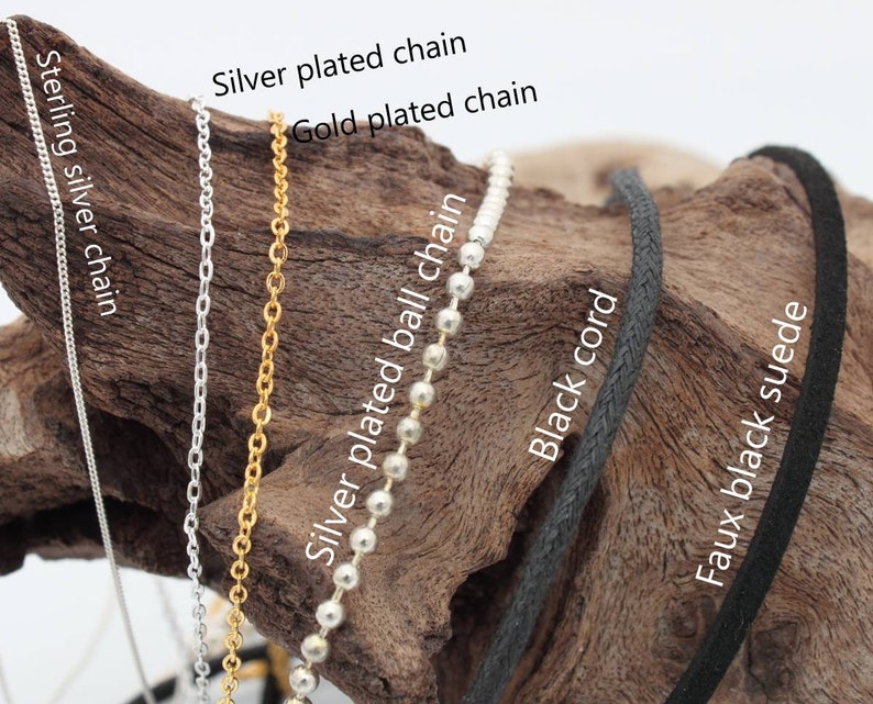 May include: Close-up of six different types of chain and cord, including sterling silver chain, gold plated chain, silver plated chain, silver plated ball chain, black cord, and faux black suede.
