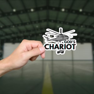 May include: A black and white sticker featuring a helicopter and the text "GOD'S CHARIOT".