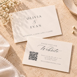 May include: Two rectangular cream-coloured wedding cards with black text. The top card reads OLIVIA & EVAN, SATURDAY, 17 JUNE 20XX | 6:30PM. The bottom card features a QR code, the text PLEASE VISIT OUR Website, and WILLIAMWEDDING.COM.