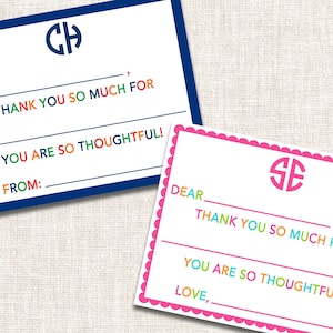 May include: Two personalized thank you cards. One card has a blue border and a monogram in the upper center. The other card has a pink scalloped border and a monogram in the upper center. Both cards have the text "Dear", "Thank you so much for", and "You are so thoughtful!"