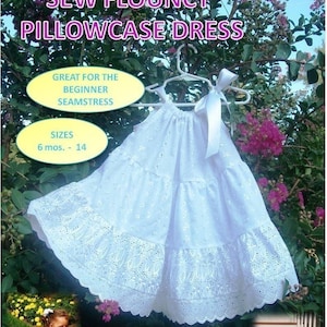 May include: A white eyelet pillowcase dress with a white ribbon. The dress has a gathered neckline and a tiered skirt. The dress is hanging on a white hanger. The text "Sew Flouncy Pillowcase Dress" is at the top of the image. The text "Great for the Beginner Seamstress" is in a yellow circle. The text "Sizes 6 mos. - 14" is in a yellow circle.