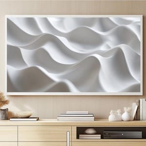 May include: A white framed television with a white abstract image of waves on the screen. The television is mounted on a wall above a wooden entertainment center with a black media player and books.