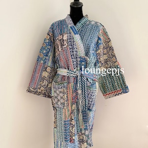 May include: A blue and green patterned robe with a sash. The robe is made of a patchwork of different fabrics and has a relaxed fit.